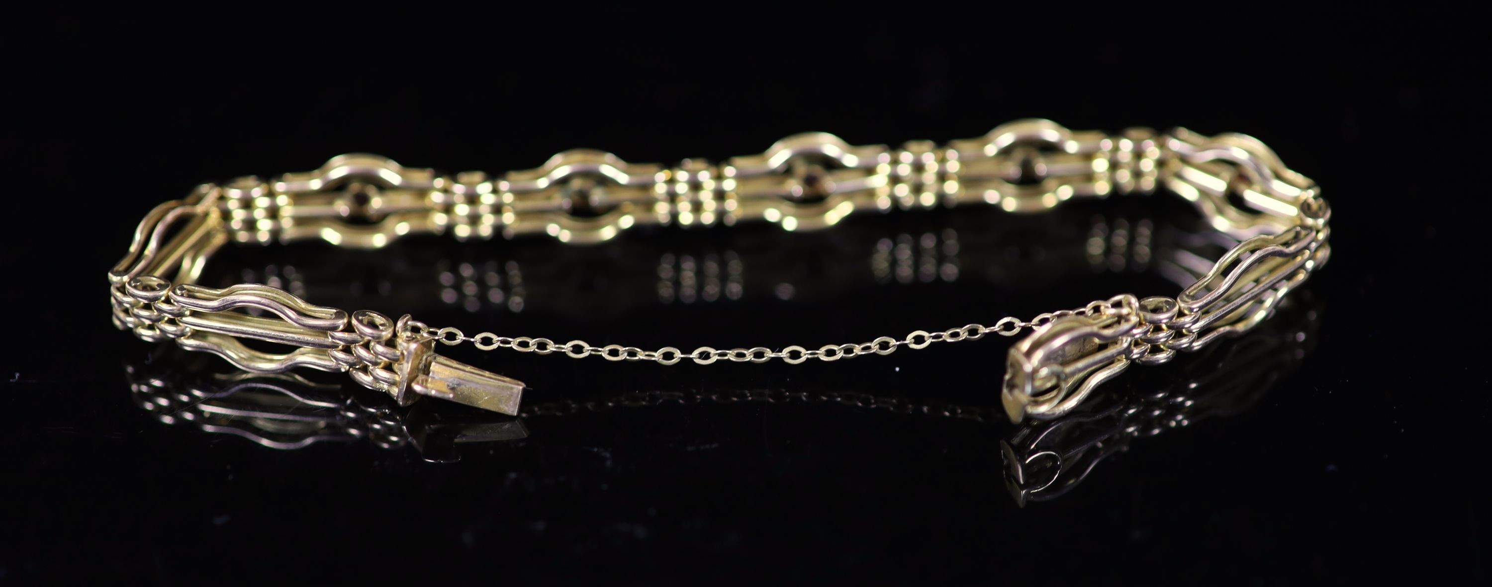An Edwardian 15ct gold, three stone ruby and two stone diamond set fancy link bracelet